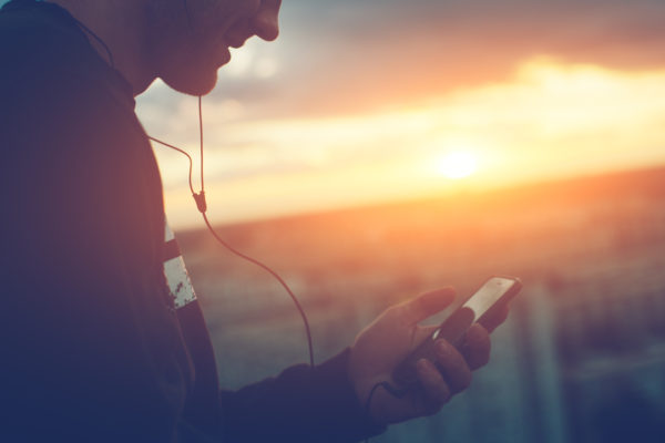 Man listening to the power of meditation on his phone