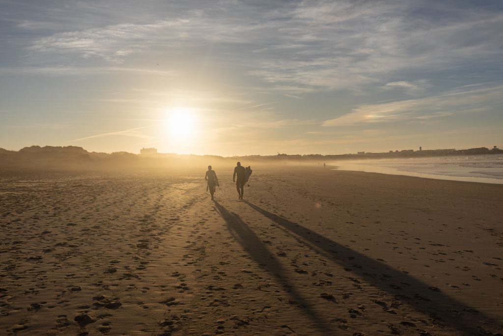 Surfers on Baleal Beach at sunset